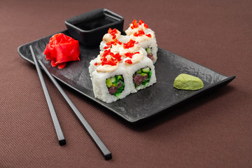 sushi on a black plate