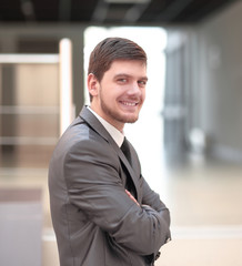 modern successful businessman on background of office