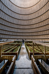 man in Interior of a abandoned cooling tower in power plant