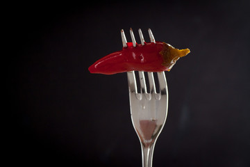 Red pepper isolated on the black background