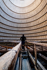 Naklejka premium man in Interior of a abandoned cooling tower in power plant