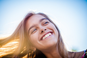 Girl in the spring. Beautiful smiling girl.  Tourist girl on vacation. Travel and Vacation. Wind...
