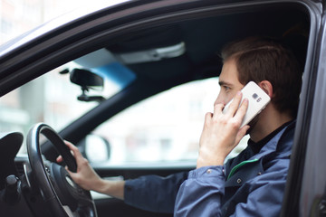 successful man talking on mobile phone in the car