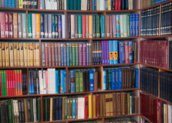 Blurred image of bookshelves in a public library. School library. Education concept