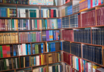 Blurred image of bookshelves in a public library. School library. Education concept