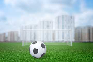 3d rendering of football ball, gate and field with city buildings on the background