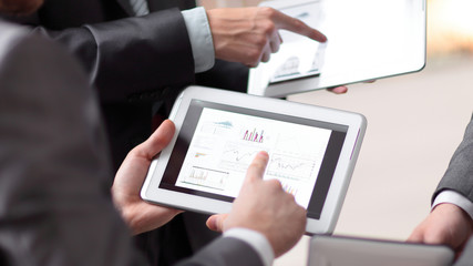 Hands of people working with tablet computer. Technology