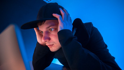 A young guy is a programmer working on a computer in a beautiful office. The programmer made a...