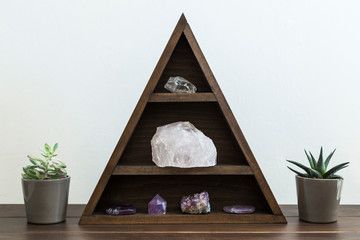 Triangular Crystal Shelf with Succulent Plants either side on a Wooden Surface