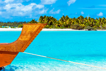 Wooden carved boat on a sandy beach in Aitutaki island, Cook Islands, South Pacific. With selective focus. - obrazy, fototapety, plakaty