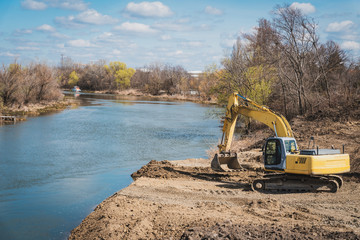 a large dredger prepares the land for the construction of a bridge
