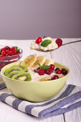 porridge with fruit on wooden background
