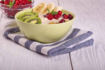porridge with fruit on wooden background