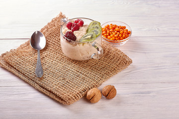 porridge with fruit on wooden background