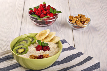 porridge with fruit on wooden background