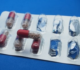 The drug in capsules. Capsules lie in plastic transparent packaging.