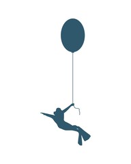 The young man in diver suit flying with toy balloon
