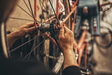 Bicycle mechanic in a workshop in the repair process.
