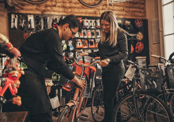 Obraz na płótnie Canvas Young woman in bicycle shop.