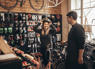 Young woman in bicycle shop.