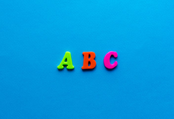 letters abc from plastic magnetic letters on blue background