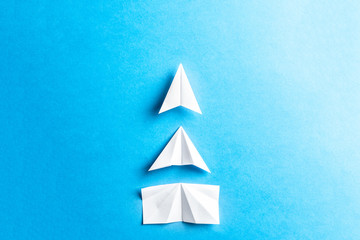 Development attainment, motivation, growth concept. Business concept of goals, success, achievement and challenge. White paper airplanes under construction on blue background. Horizontal composition.