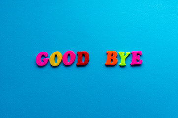 words good bye from plastic magnetic letters on blue background