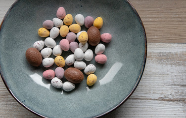 Cracked chocolate easter eggs in a ceramic bowl