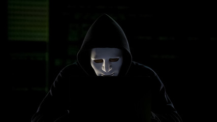 Hacker in mask breaking government servers, cyberterrorism, internet security