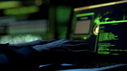 Male hands typing computer code, security program for database or servers