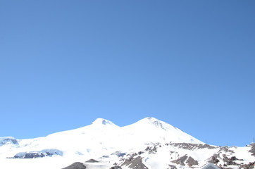 Fototapeta na wymiar Mountains with peaks covered with snow, Elbrus and the Caucasus