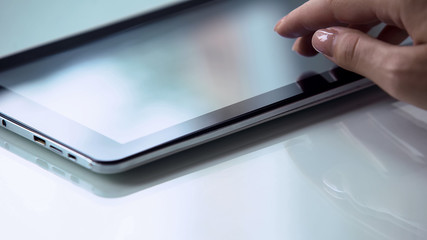 Hand using touchscreen tablet, modern personal computer technology, social media