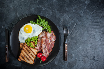 Fried eggs with bacon and peas