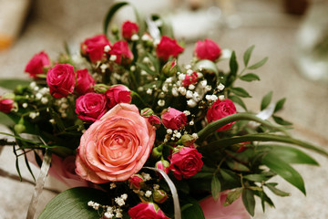  a bouquet of small roses and a large.  holiday gift. selective focus