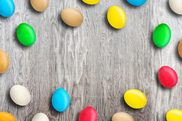 Multicolored Easter eggs on wooden background. Copy space. Easter.