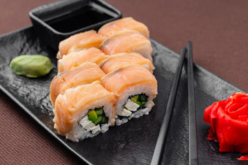 sushi on a black plate