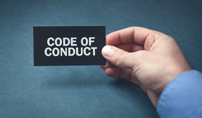 Man hand holding card. Code of Conduct