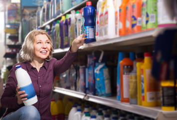 Mature female with selecting fabric conditioner