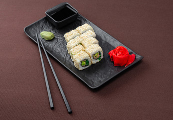 sushi on a black plate