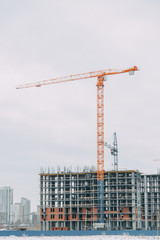 Construction of modern high-rise buildings. Cranes and machinery