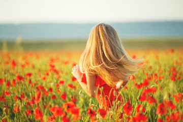 Child in a field with flowers