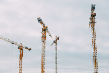 Fototapeta na wymiar Construction of modern high-rise buildings. Cranes and machinery