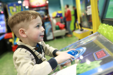 Boy plays arcade game