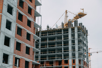 Construction of modern high-rise buildings. Phased construction of structures in winter.