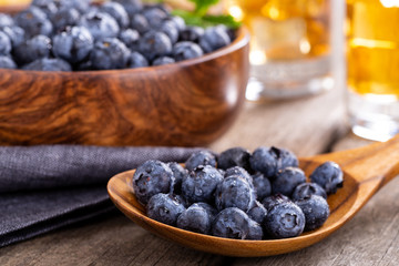 Closeup of a Wooden Spoonful of Fresh Blueberries