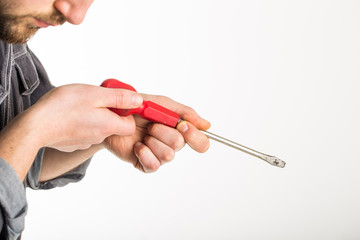 Hand holding screwdriver isolated over white background