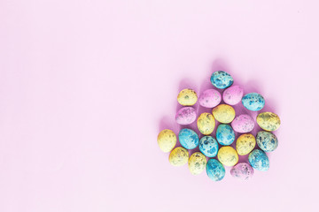 Painted easter eggs lying on purple background. Top view. Flat lay. Place for text