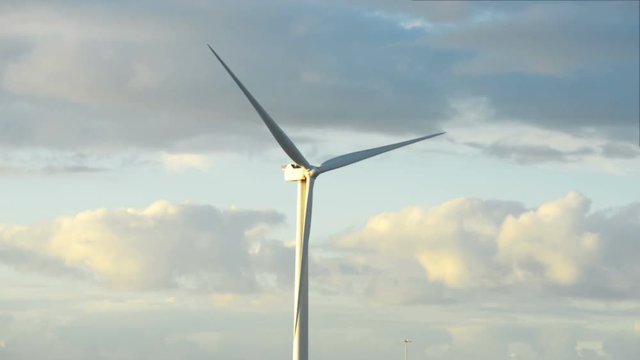 Energy wing power turbine rotates on sunset sky background. Full HD footage