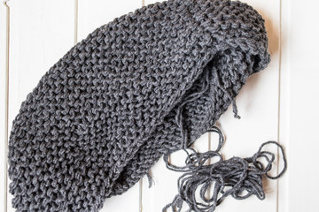 Gray knitted scarf on the white background
