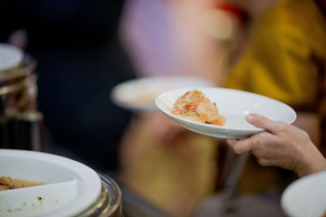 scooping the food, buffet food at restaurant, catering 